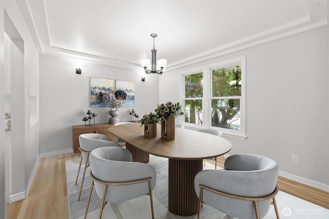 3505 W 43rd Ave, Seattle, WA 98199 - dining space with a chandelier, a raised ceiling, and light wood-style floors