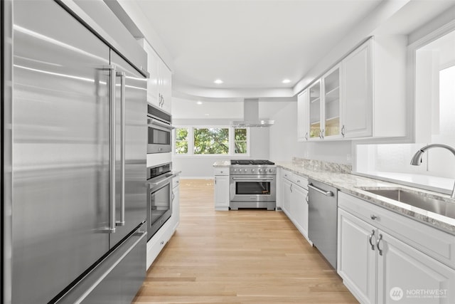 3505 W 43rd Ave, Seattle, WA 98199 - kitchen featuring high end appliances, light wood finished floors, white cabinetry, recessed lighting, and light stone countertops