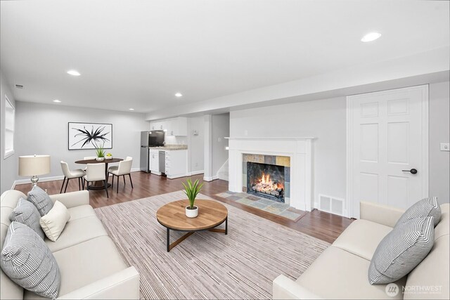 3505 W 43rd Ave, Seattle, WA 98199 - living area with wood finished floors, recessed lighting, and a tile fireplace