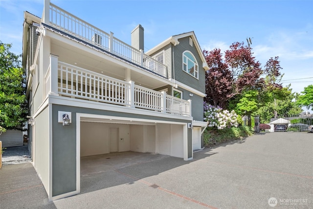 3505 W 43rd Ave, Seattle, WA 98199 - view of front of home featuring a balcony, an attached garage, and a chimney