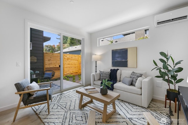 9021A 13th Ave NW, Seattle, WA 98117 - living room featuring a wall mounted AC and light wood-style floors