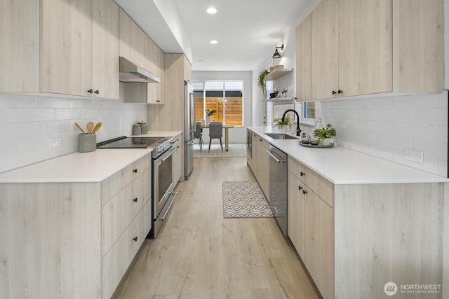 9021A 13th Ave NW, Seattle, WA 98117 - kitchen with light brown cabinetry, appliances with stainless steel finishes, extractor fan, modern cabinets, and recessed lighting
