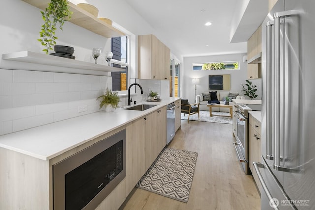 9021A 13th Ave NW, Seattle, WA 98117 - kitchen with high end appliances, light brown cabinets, modern cabinets, and recessed lighting