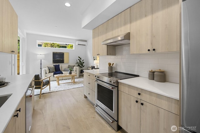 9021A 13th Ave NW, Seattle, WA 98117 - kitchen featuring appliances with stainless steel finishes, light brown cabinets, a wall mounted air conditioner, extractor fan, and recessed lighting