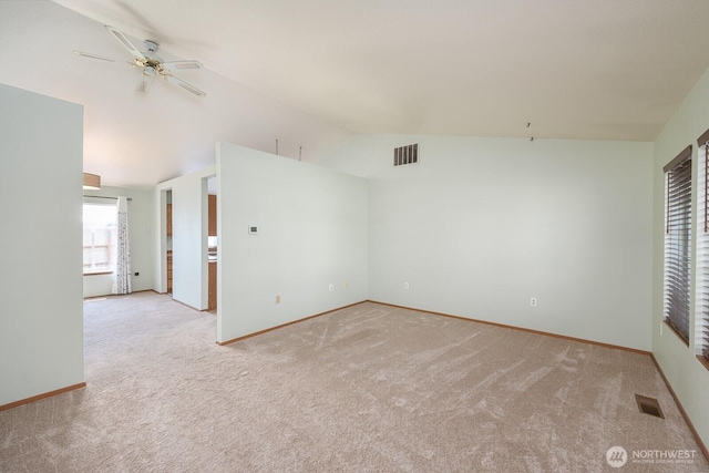 206 E St NE, Ephrata, WA 98823 - spare room featuring light colored carpet, vaulted ceiling, and ceiling fan