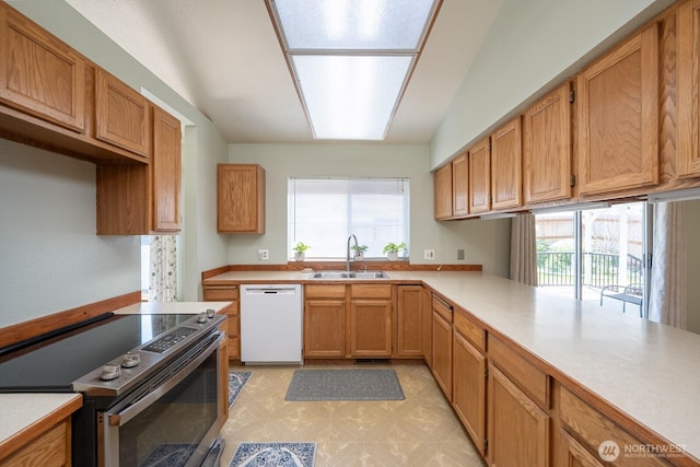 206 E St NE, Ephrata, WA 98823 - kitchen featuring stainless steel electric stove, white dishwasher, light countertops, and light floors