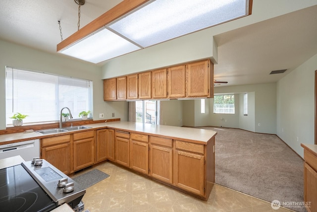 206 E St NE, Ephrata, WA 98823 - kitchen featuring a peninsula, dishwasher, light countertops, open floor plan, and vaulted ceiling