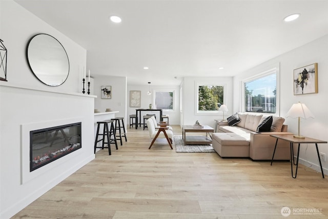 12448 Occidental Ave S, Seattle, WA 98168 - living area featuring light wood-type flooring, recessed lighting, and a glass covered fireplace