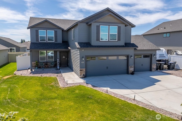 4211 W Heaverlo Dr, Moses Lake, WA 98837 - craftsman-style house featuring a porch, roof with shingles, concrete driveway, stone siding, and a garage
