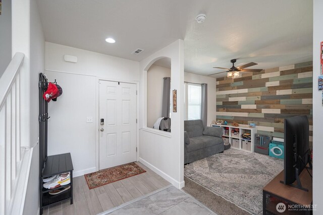 4211 W Heaverlo Dr, Moses Lake, WA 98837 - entrance foyer featuring a ceiling fan, arched walkways, and wooden walls