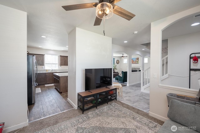 4211 W Heaverlo Dr, Moses Lake, WA 98837 - living room featuring a ceiling fan, arched walkways, stairway, and recessed lighting