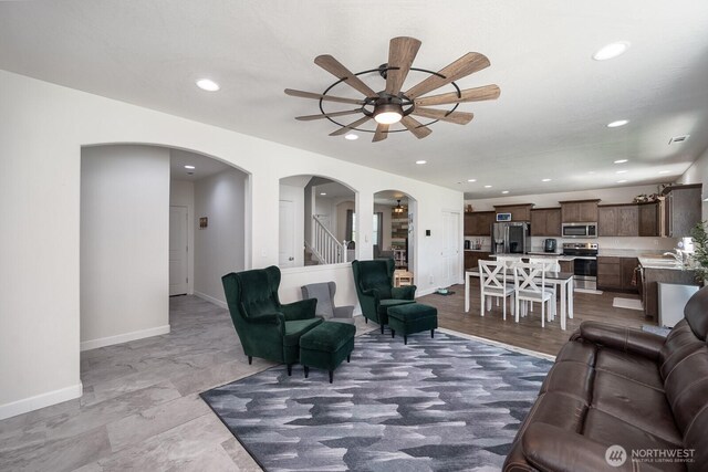 4211 W Heaverlo Dr, Moses Lake, WA 98837 - living room with a ceiling fan, arched walkways, and recessed lighting