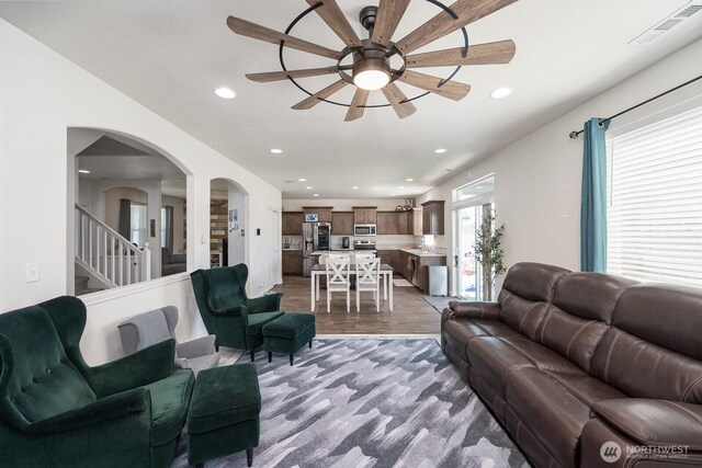 4211 W Heaverlo Dr, Moses Lake, WA 98837 - living area featuring ceiling fan, arched walkways, recessed lighting, wood finished floors, and stairway