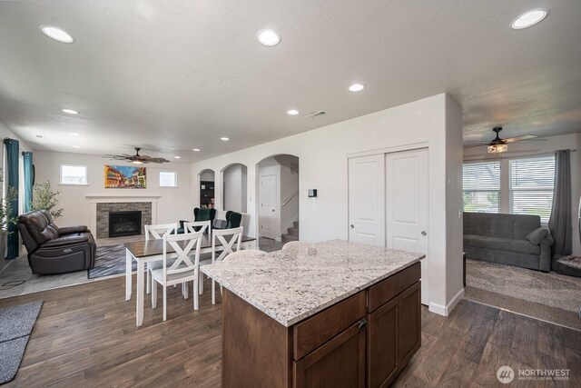 4211 W Heaverlo Dr, Moses Lake, WA 98837 - kitchen featuring ceiling fan, open floor plan, dark wood-style flooring, a fireplace, and recessed lighting