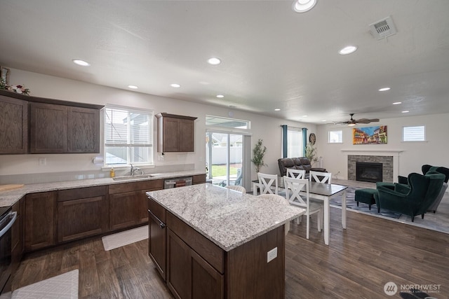 4211 W Heaverlo Dr, Moses Lake, WA 98837 - kitchen featuring a fireplace, healthy amount of natural light, recessed lighting, dark wood-type flooring, and a kitchen island