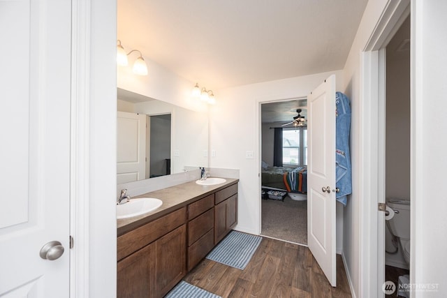 4211 W Heaverlo Dr, Moses Lake, WA 98837 - ensuite bathroom featuring double vanity, wood finished floors, and a ceiling fan