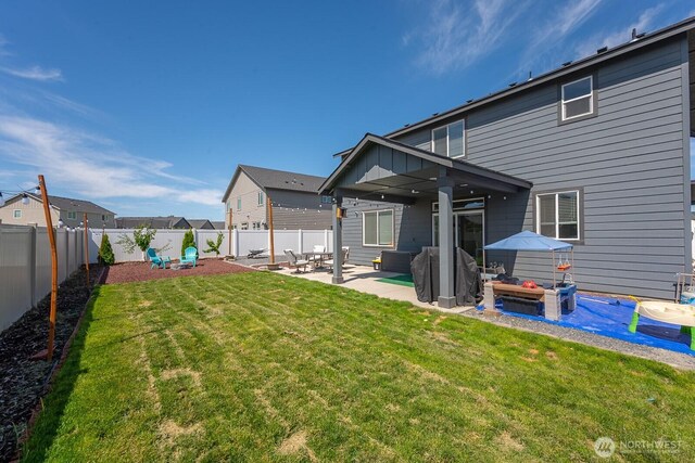 4211 W Heaverlo Dr, Moses Lake, WA 98837 - back of house with a patio, a fenced backyard, and board and batten siding