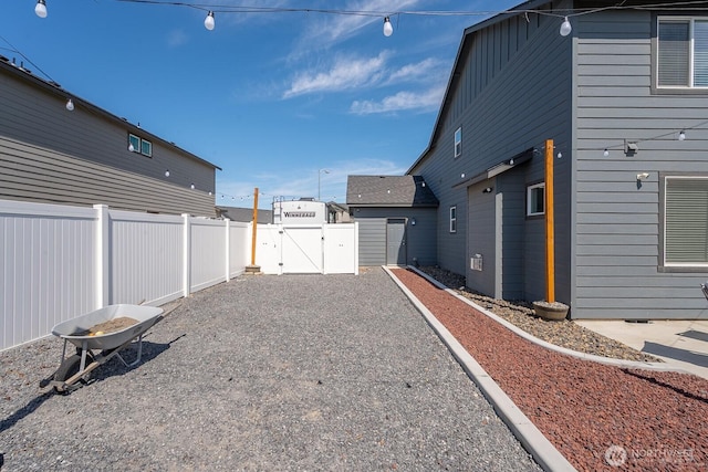 4211 W Heaverlo Dr, Moses Lake, WA 98837 - fenced backyard featuring a gate, an outdoor fire pit, and driveway