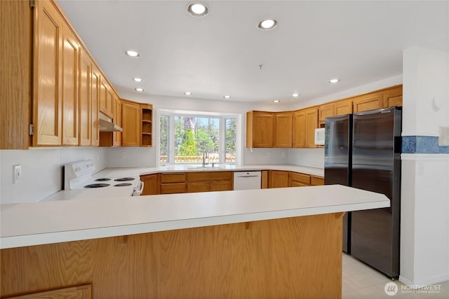 19517 Whiteman Cove Rd SW, Longbranch, WA 98351 - kitchen with white appliances, under cabinet range hood, a peninsula, light countertops, and recessed lighting