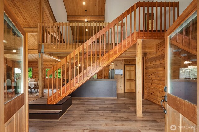 7717 252nd Ave NE, Redmond, WA 98053 - stairs with wood finished floors, wooden walls, wood ceiling, and a towering ceiling