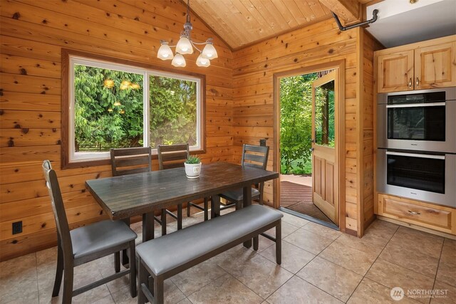 7717 252nd Ave NE, Redmond, WA 98053 - dining area with lofted ceiling, a chandelier, wooden ceiling, light tile patterned floors, and wood walls