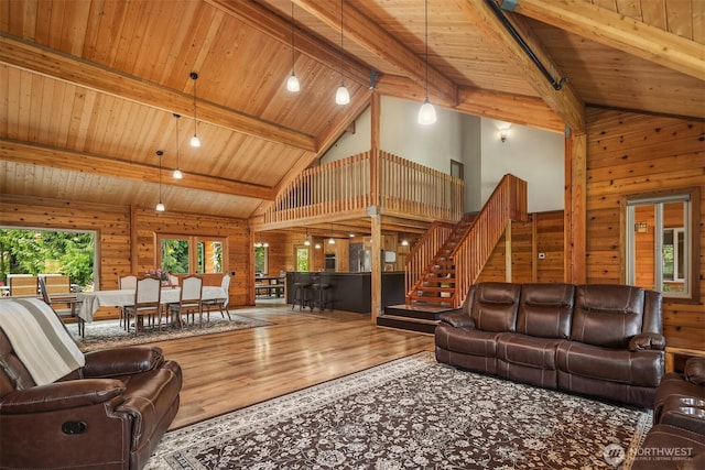 7717 252nd Ave NE, Redmond, WA 98053 - living room with high vaulted ceiling, a wooden ceiling with exposed beams, wood walls, wood finished floors, and stairway
