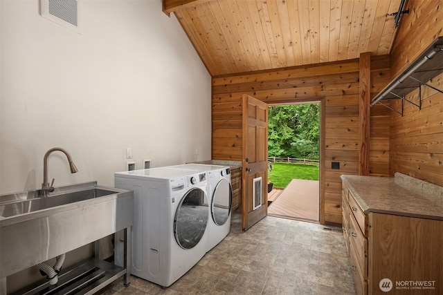 7717 252nd Ave NE, Redmond, WA 98053 - laundry room featuring washer and dryer, wooden walls, cabinet space, and wooden ceiling