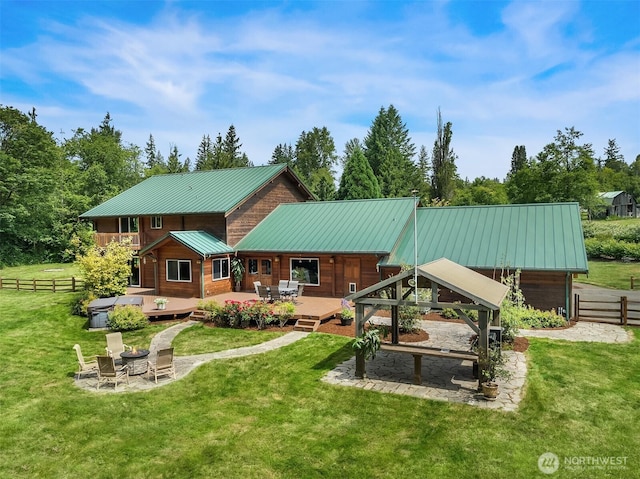 7717 252nd Ave NE, Redmond, WA 98053 - rear view of property featuring a wooden deck, an outdoor fire pit, and a metal roof