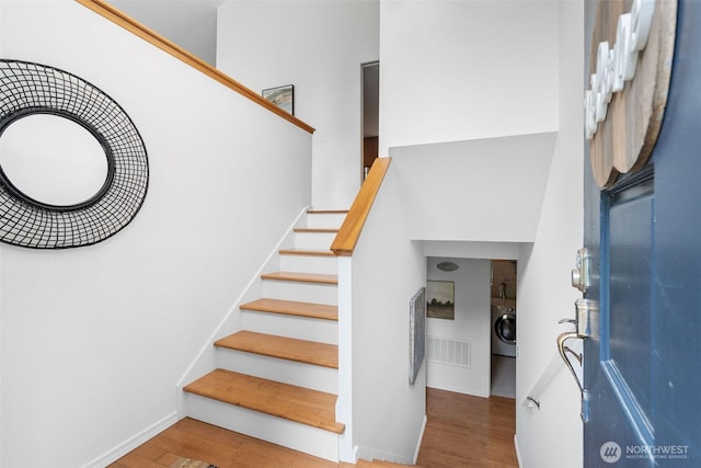 14913 SE 47th Ct, Bellevue, WA 98006 - staircase featuring washer / dryer and wood finished floors