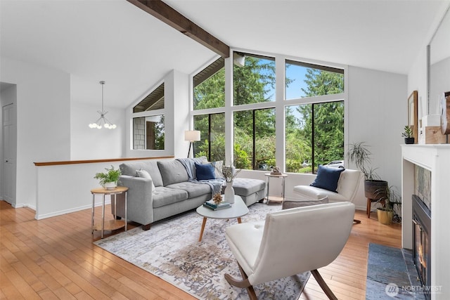 14913 SE 47th Ct, Bellevue, WA 98006 - living room featuring a fireplace with flush hearth, light wood-style floors, and a chandelier