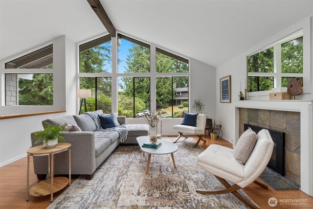 14913 SE 47th Ct, Bellevue, WA 98006 - living area with a tiled fireplace, healthy amount of natural light, and wood finished floors
