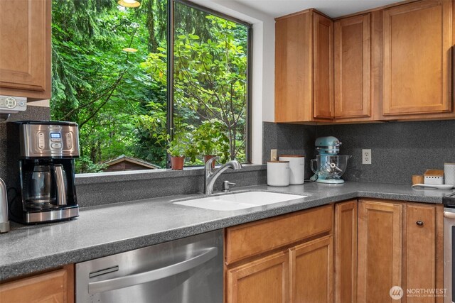 14913 SE 47th Ct, Bellevue, WA 98006 - kitchen with stainless steel dishwasher, backsplash, and brown cabinets
