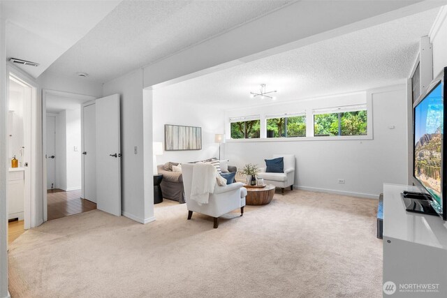 14913 SE 47th Ct, Bellevue, WA 98006 - carpeted living area featuring a textured ceiling