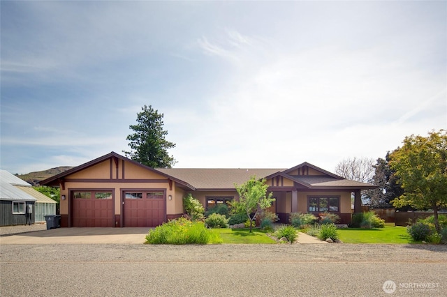 512 May St, Twisp, WA 98856 - view of front of home featuring a garage, driveway, stucco siding, and a front yard