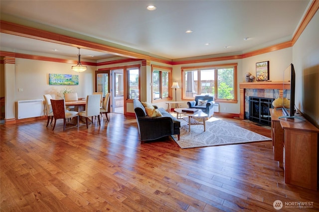 512 May St, Twisp, WA 98856 - living area featuring ornamental molding, a tiled fireplace, wood-type flooring, and recessed lighting