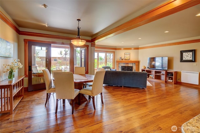 512 May St, Twisp, WA 98856 - dining area featuring ornamental molding, light wood finished floors, and a tiled fireplace