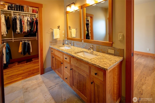 512 May St, Twisp, WA 98856 - bathroom featuring double vanity, wood finished floors, and a spacious closet