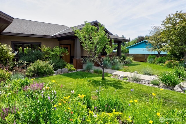 512 May St, Twisp, WA 98856 - view of front of home with a front yard, stucco siding, and a shingled roof
