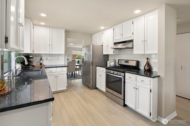 2554 174th Ave NE, Redmond, WA 98052 - kitchen with stainless steel appliances, under cabinet range hood, light wood-style flooring, white cabinets, and recessed lighting