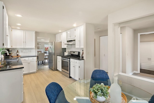 2554 174th Ave NE, Redmond, WA 98052 - kitchen featuring appliances with stainless steel finishes, under cabinet range hood, dark countertops, tasteful backsplash, and recessed lighting
