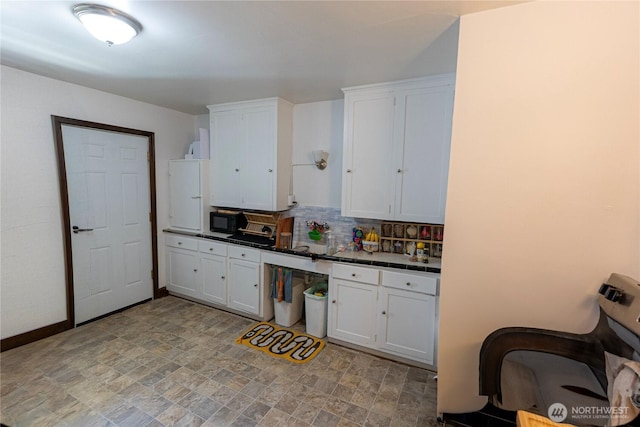 801 Martin Luther King Jr Way, Tacoma, WA 98405 - kitchen featuring backsplash, white cabinets, and black microwave