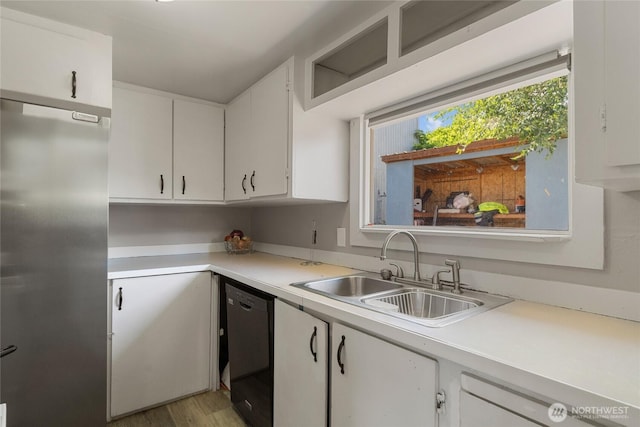 904 Cashmere St, Wenatchee, WA 98801 - kitchen featuring freestanding refrigerator, black dishwasher, light countertops, and white cabinets