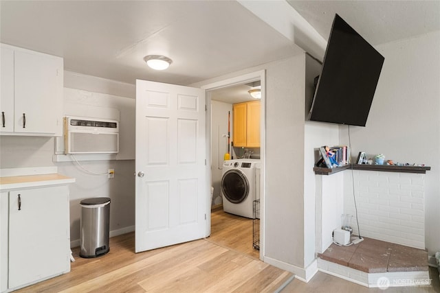 904 Cashmere St, Wenatchee, WA 98801 - laundry area with washer / clothes dryer, cabinet space, light wood-style floors, and an AC wall unit
