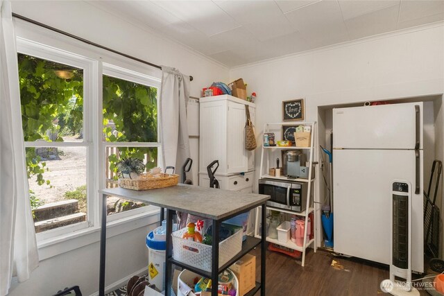 904 Cashmere St, Wenatchee, WA 98801 - kitchen with freestanding refrigerator, stainless steel microwave, dark wood finished floors, and ornamental molding