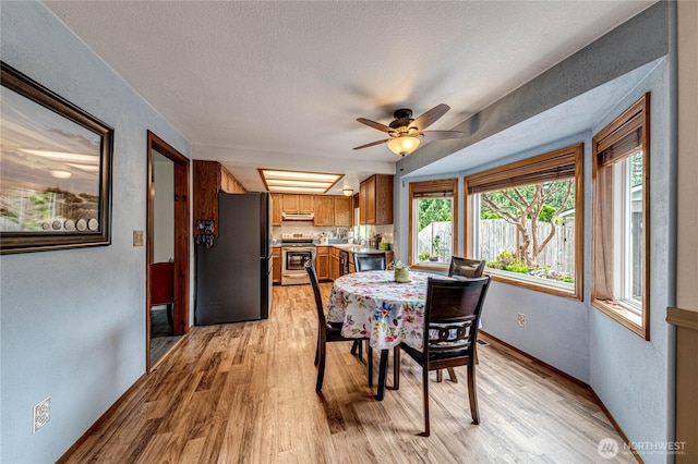 1722 172nd St SE, Bothell, WA 98012 - dining area featuring light wood finished floors, ceiling fan, a textured ceiling, and a textured wall