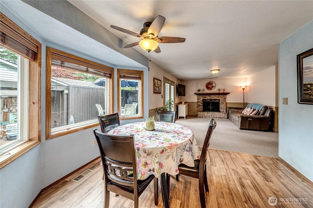 1722 172nd St SE, Bothell, WA 98012 - dining space featuring healthy amount of natural light, a fireplace, light wood finished floors, and ceiling fan