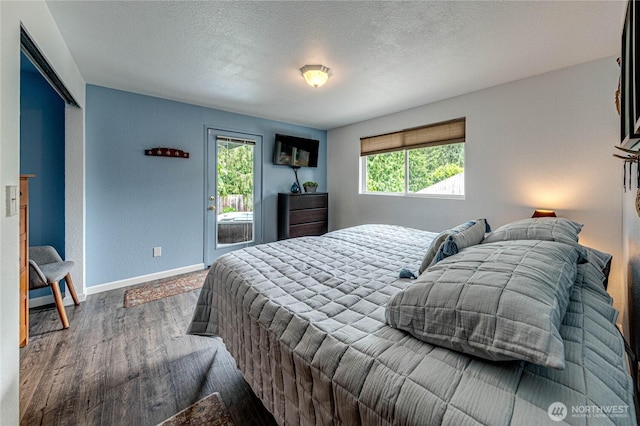 1722 172nd St SE, Bothell, WA 98012 - bedroom featuring wood finished floors, access to exterior, and a textured ceiling