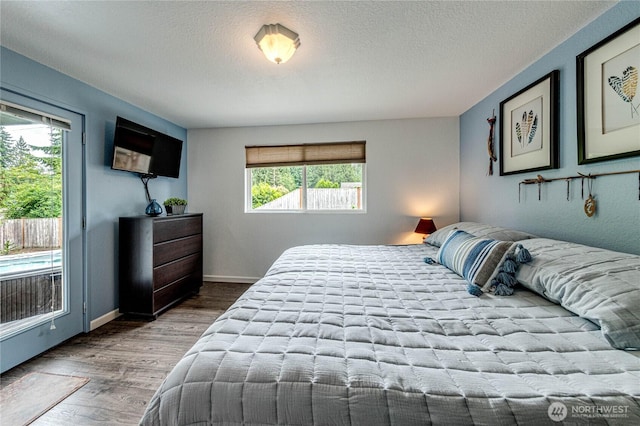 1722 172nd St SE, Bothell, WA 98012 - bedroom featuring multiple windows, wood finished floors, and a textured ceiling