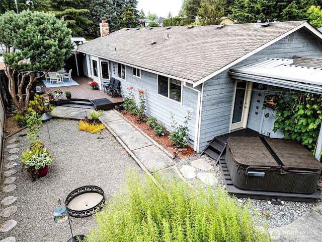 1722 172nd St SE, Bothell, WA 98012 - rear view of property featuring a hot tub, a wooden deck, roof with shingles, a chimney, and outdoor dining space