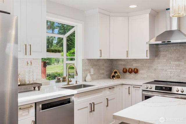 331 137th St SW, Everett, WA 98208 - kitchen with appliances with stainless steel finishes, wall chimney range hood, white cabinetry, backsplash, and recessed lighting